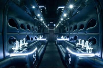 a party bus with a lot of seats inside of it.