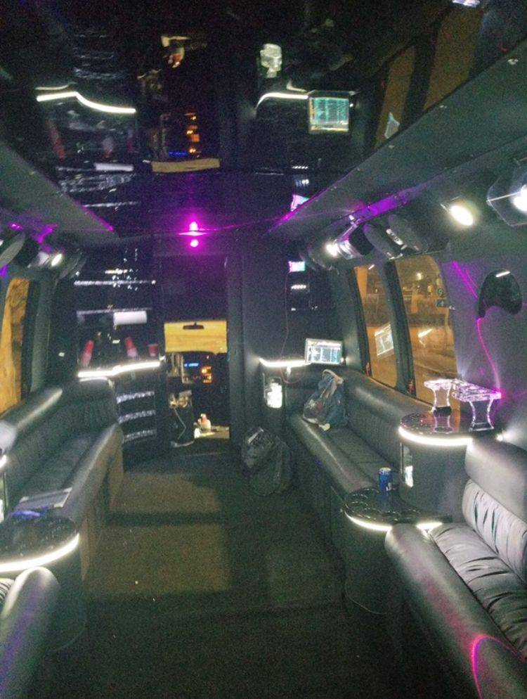 the inside of a limo with purple lights.