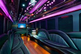 the interior of a party bus with purple lights.