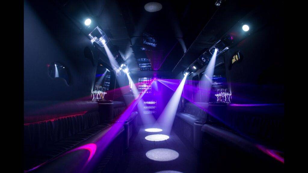 a party bus with lights and spotlights in the dark.