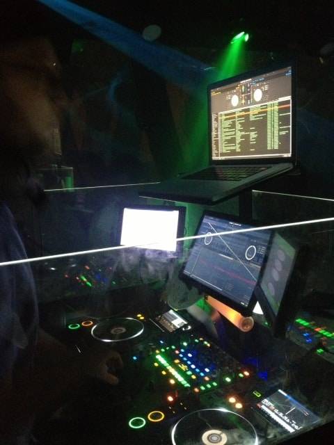 a dj mixing in front of a party bus.