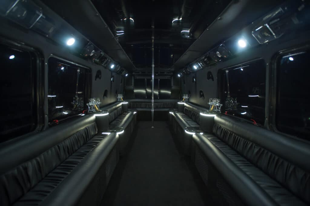 a dimly lit bus with seats and lights.