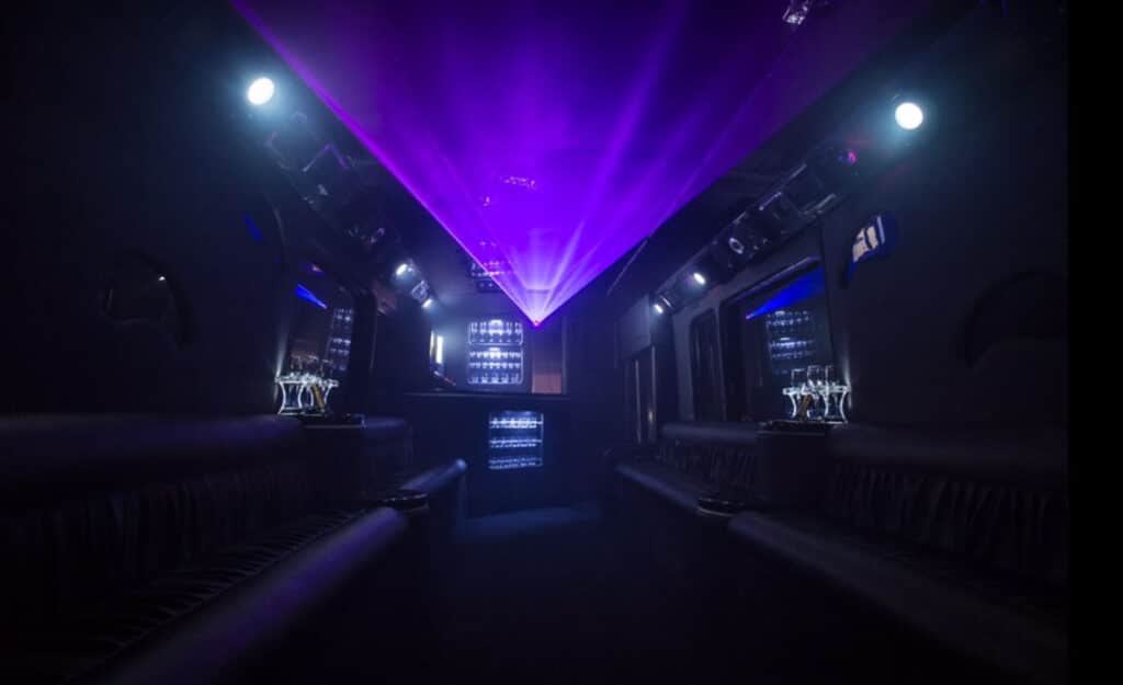 a dimly lit party bus with purple lights.